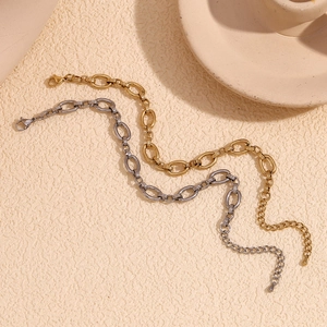 Minimalist 14K gold and silver stainless steel O-link anklet set on a neutral background