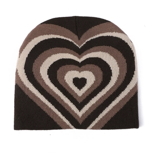 Detailed knit texture of the coffee brown beanie with multi-layered heart pattern