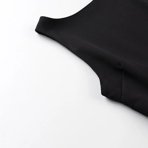 Close-up of high-quality black woven fabric texture and stitching details of the dress