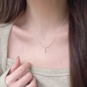 Detail of S925 sterling silver water drop necklace worn on neck with ripple pendant