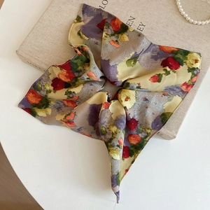 Macro detail of large floral acrylic hair scrunchie with vintage oil painting pattern