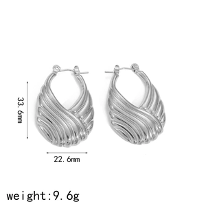Silver stainless steel ribbed hoop earrings measuring 33.6mm in height and 22.6mm in width