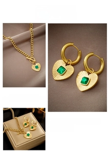 Detail of vintage emerald heart necklace and hoop earrings with toggle clasp design