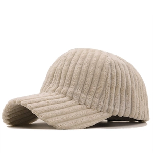 Detailed side view of off-white corduroy baseball cap showing soft ribbed texture
