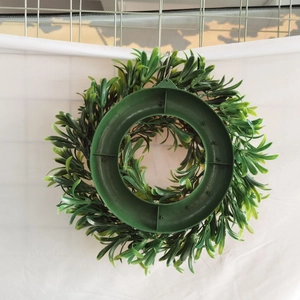Detail of the sturdy back hook and circular support structure of the Easter greenery wreath