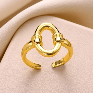 Detail of adjustable gold-plated snake ring with hollow oval and buckle accents