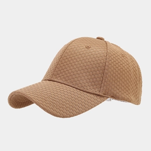 Detailed macro shot of waffle texture fabric on a camel brown vintage baseball cap