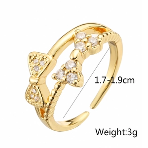 Detail showing gold bow ring with cubic zirconia, weighing 3g and adjustable 1.7-1.9cm