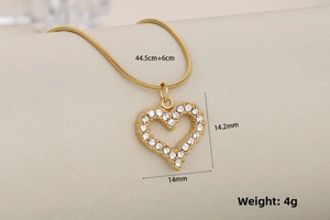 Detailed macro view of gold-plated hollow heart pendant with sparkling cubic zirconia pavé