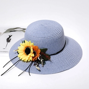 Detail of lavender straw sun hat with decorative yellow sunflower and floral accents