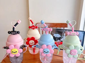 Four colorful sunflower water bottles with straws in pink beige blue and green colors