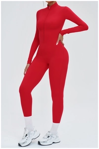 Detailed view of red long sleeve yoga jumpsuit featuring a half-zip stand collar and fit