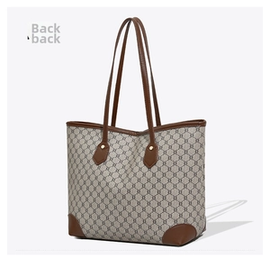 Rear view of large vintage tote bag featuring brown leather trim and monogram pattern