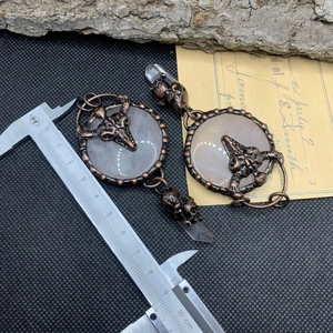 Detail shot of vintage gothic ox skull pendant with rose quartz measuring 8.5cm long