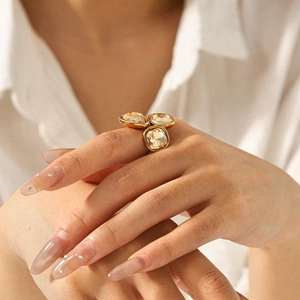 18k gold stainless steel open ring featuring three champagne stones on a model hand
