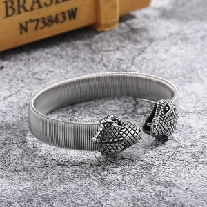 Detailed macro view of retro silver punk snake head bangle with flexible wire texture