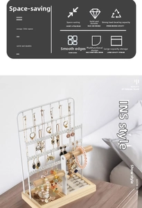 Close-up of a white jewelry organizer with wooden rod and base for earrings and necklaces
