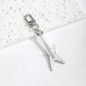 Detailed close-up of a white and silver star-shaped electric guitar keychain accessory