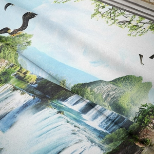 Detail shot of the woven landscape tapestry fabric featuring eagles and lush waterfalls