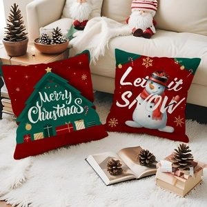 Red Christmas pillow covers set with snowman and tree patterns on white faux fur carpet