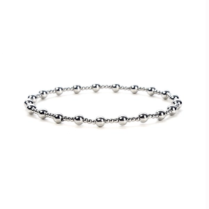 Macro shot of silver beaded bracelet showing high-shine metallic finish and elastic string