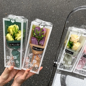 Detail of soap flower bouquets in gift boxes with yellow, purple, and pink roses