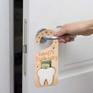 Customized wooden tooth fairy door hanger with white pocket on a door handle
