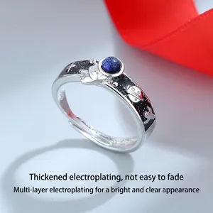 Astronaut couple rings with blue space stone and planet decor in silver finish