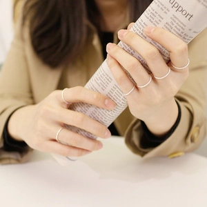 Minimalist S925 sterling silver textured thin rings stacked on a model's hand