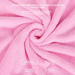Macro detail of soft pink coral fleece fabric showing fluffy double-sided plush texture