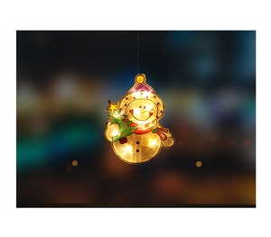 Detail of LED snowman window light with warm yellow glow and festive red scarf