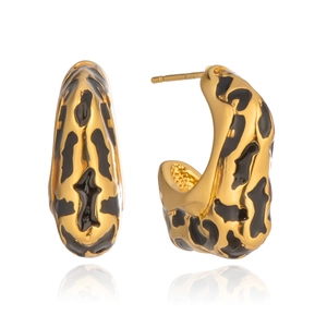 Detailed view of C-shaped gold earrings with black leopard print enamel and glossy finish
