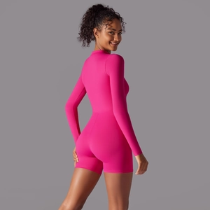 Rear view of fuchsia long sleeve athletic bodysuit for women showing slim fit design