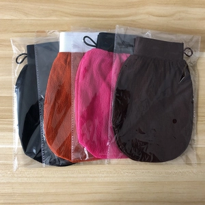 Detailed view of four exfoliating bath gloves in black, orange, pink and brown colors