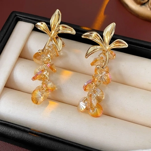 Close-up of vintage flower tassel earrings with amber crystal beads in a jewelry box