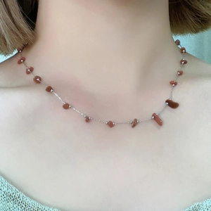 Elegant stainless steel necklace featuring irregular reddish-brown natural stone pendants