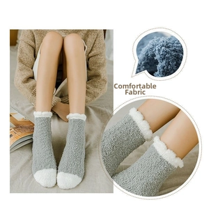 Close-up of grey coral fleece socks showing soft plush texture and wave-edge cuffs