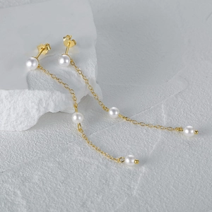 Macro view of S925 silver fringe long chain pearl earrings with elegant gold finish