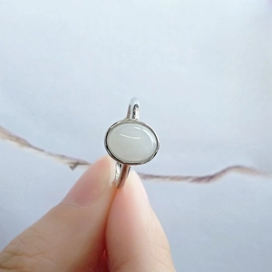 Macro shot of 925 silver ring featuring a white oval gemstone and minimalist thin band