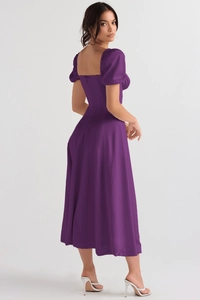 Detail view of deep purple slim-fit dress with puff sleeves and invisible back zipper