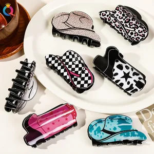 Macro detail of western cowboy hat and boot hair clips in assorted acrylic patterns