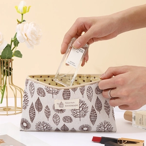 Canvas cosmetic bag detail view showing large capacity and portable design for daily makeup storage.