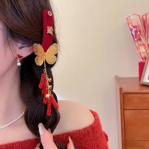 Red velvet butterfly hair clip with gold fringe tassels and festive embroidery