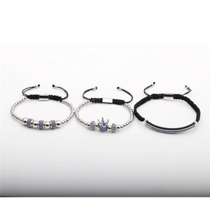 Detailed view of three-piece adjustable braided bracelets with blue zircon crown charms