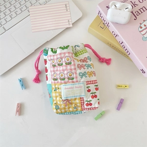 Detail of the soft quilted floral drawstring camera storage bag with Sorakka Studio label