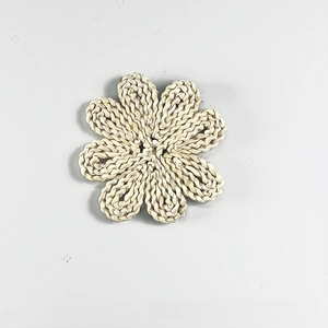 Detailed close-up of a handmade bohemian natural straw flower wall hanging decoration