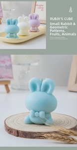 Detailed view of cute rabbit scented candles with bow tie details in multiple colors