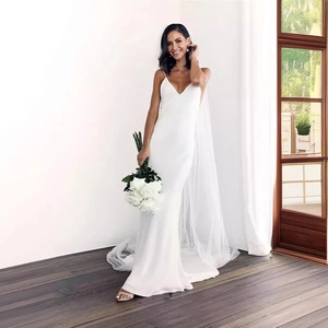 Elegant white mermaid wedding dress with spaghetti straps and a deep V-neck tulle tail