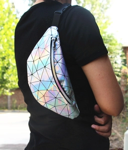 Close-up of holographic geometric fanny pack with colorful laser patches and black strap