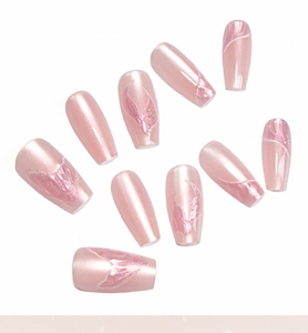 Detailed macro view of 10-piece pink cat-eye press-on nails with white floral art